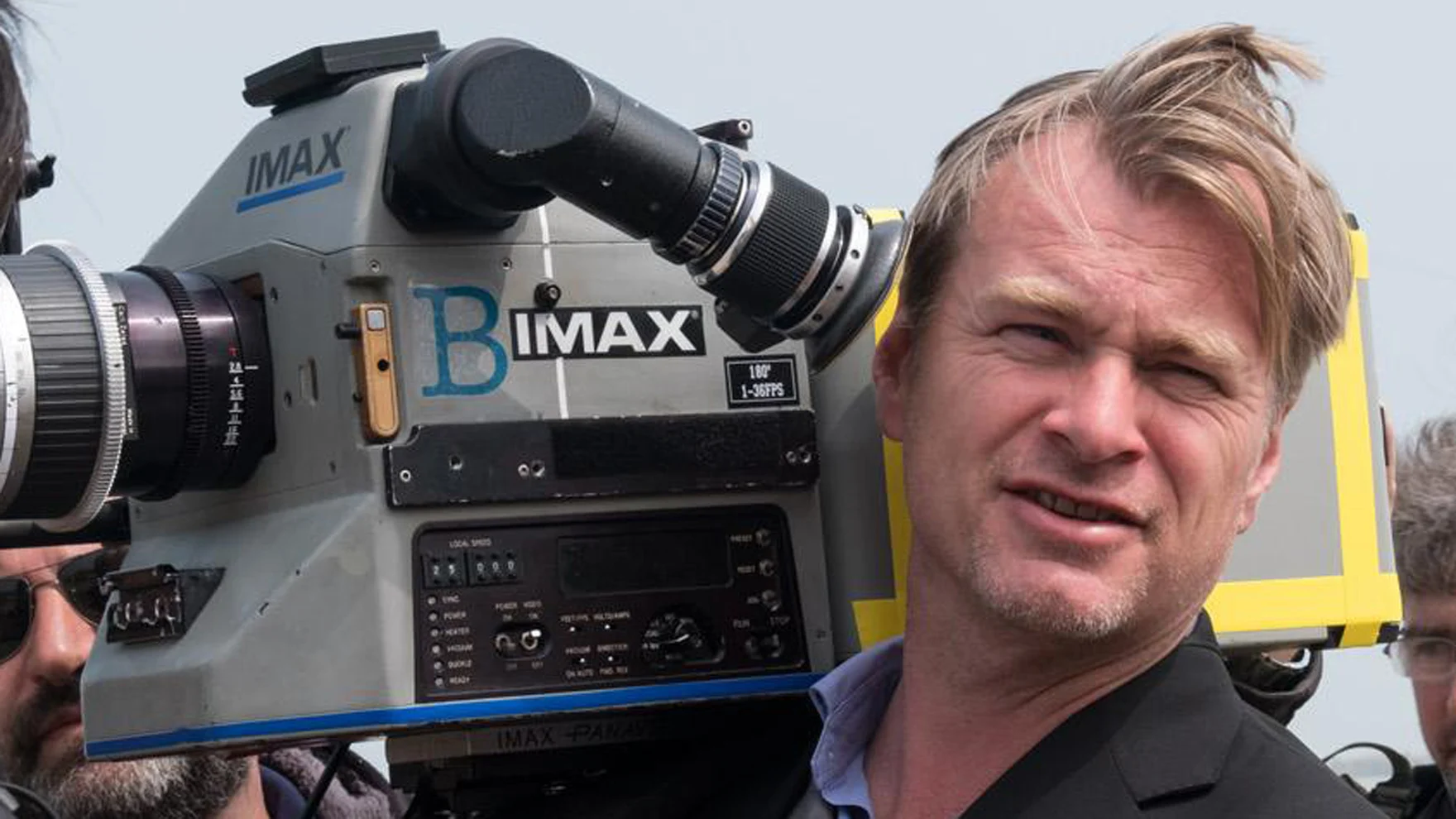 Image of director Christopher Nolan holding an IMAX camera.