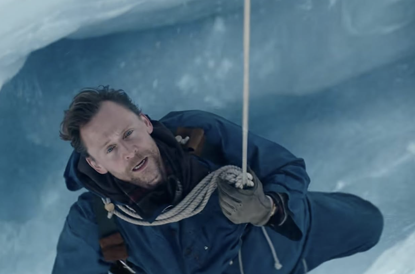 Image of Tom Hiddleston, caught in a crevice as he tries to climb Mount Everest.